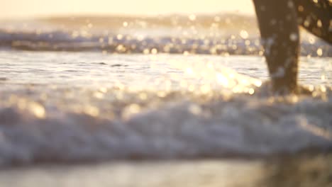 Close-Up-of-Legs-Walking-in-the-Surf