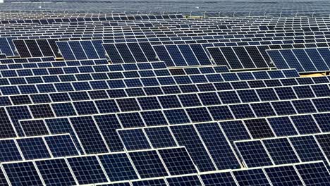 Aerial-view-looking-down-over-vast-geometric-patterned-solar-panel-array-in-the-Mojave-desert