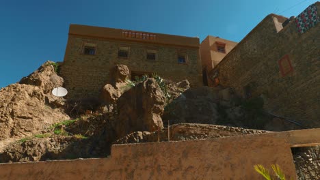 typical moroccan mountain houses made from rocks and mud, panning right