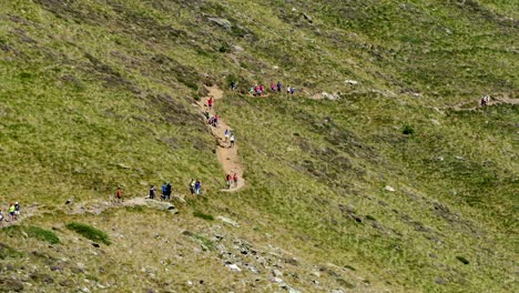 mountain road with many hikers.