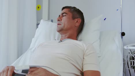 male patient using mobile phone in the ward at hospital