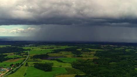 dark rain clouds begin to arrive over the green countryside of riga, latvia