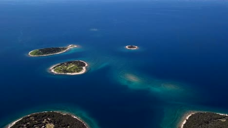 flight over small desert islands and colorful sea, brijuni park, croatia.