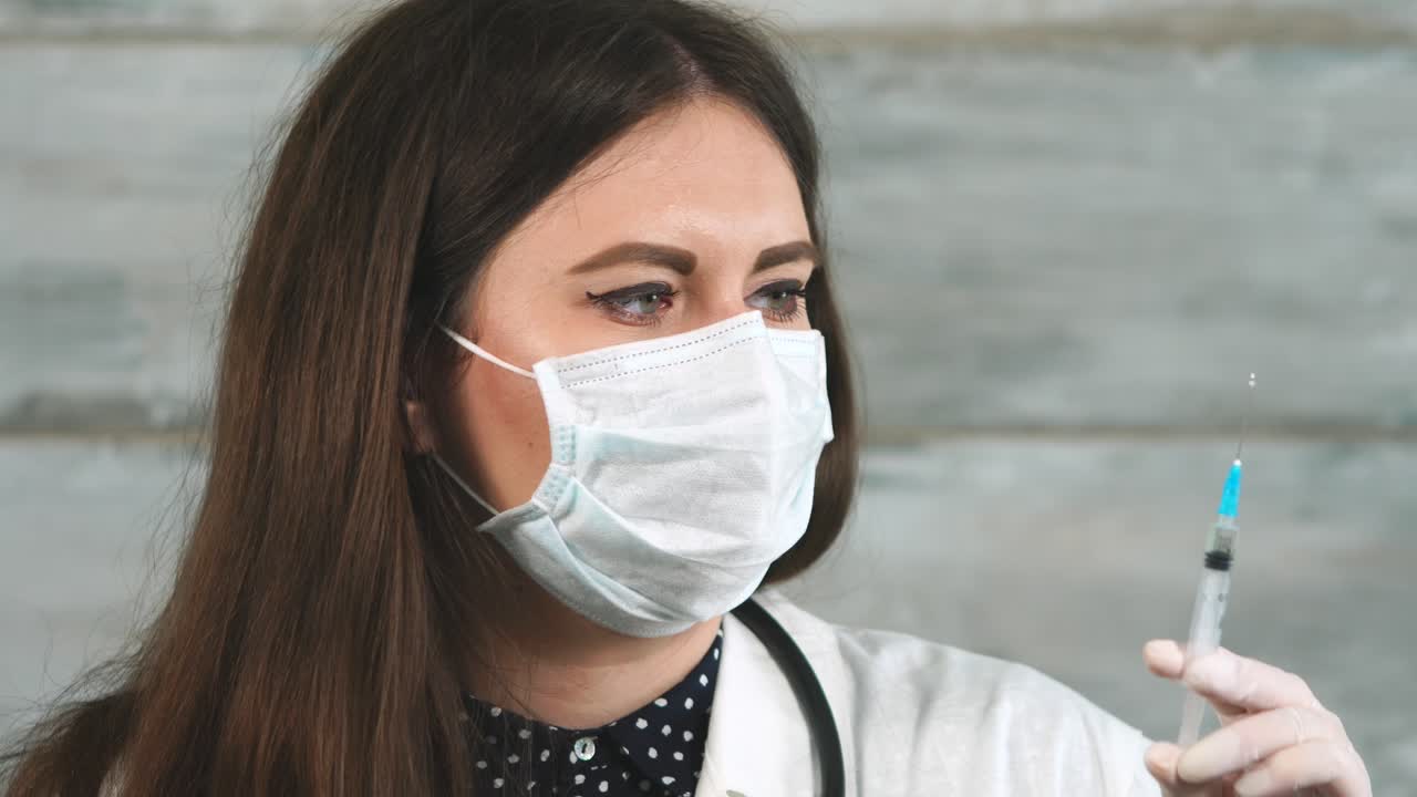 Doctor Examining Syringe