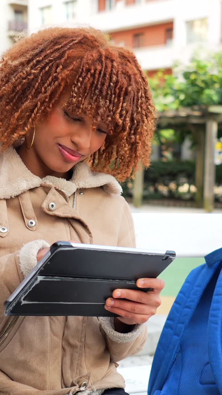 Woman using tablet outdoors