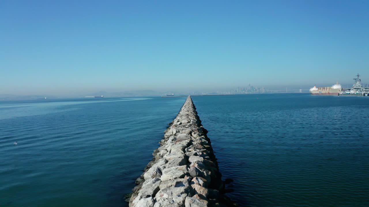 A long pass over the breaker wall in the bay. Built to tame the larger waves that might develop and hit the shore