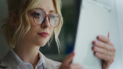 woman uses digital tablet close-up on face