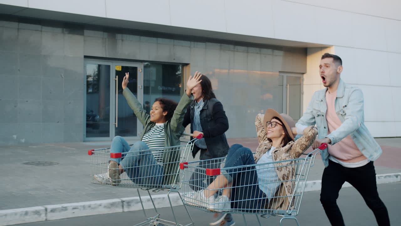Friends having fun running with shopping carts