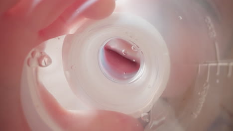 preschooler drinks water through white silicone nipple