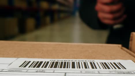 scanner scan delivery box in storage, e-commerce shop, man packing goods and clothes second hand delivery market, courier packaging and shipping workspace with supplies and technology, online sales.