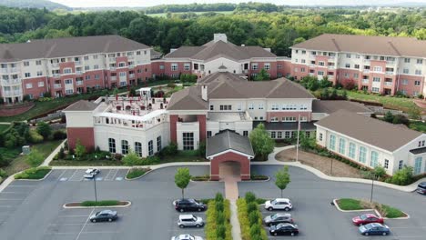 descending aerial on retirement home community, assisted living, senior citizen home, large ccrc complex for continuing care, united states of america, usa baby boomer generation, healthcare facility