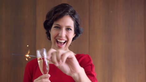 Woman-holding-sparkler-and-champagne-glass