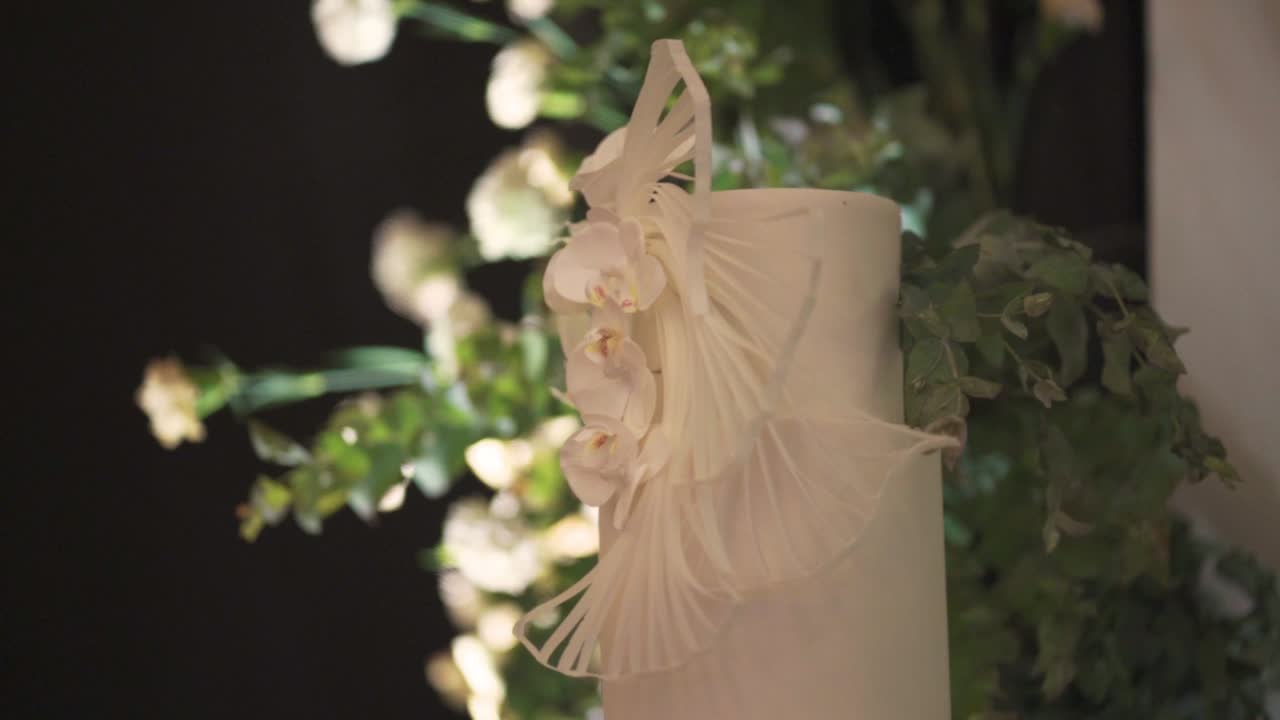 색 fondant로 만들어진 결혼 케이크와 자연 잎으로 장식