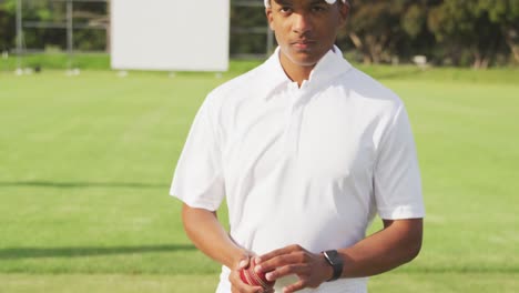 cricket player with ball looking at the camera