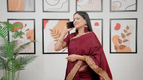 Happy-Indian-woman-talking-on-a-call