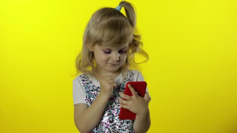 Child-girl-scrolling-social-network-posts-on-smartphone.-Remote-online-shopping,-browsing-on-phone.