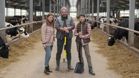 family posing inside dairy farm