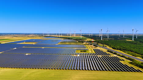 yellow agricultural fields with solar panels. wind farms located nearby. aerial perspective