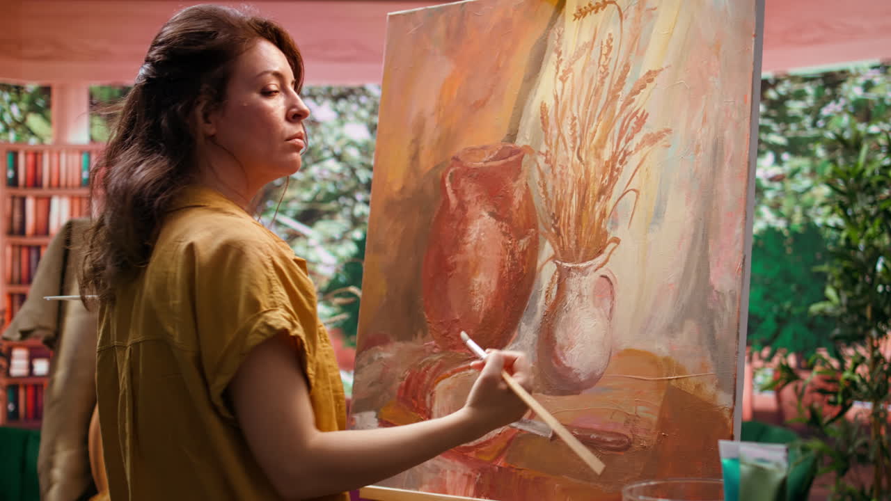 Woman painting a still life on canvas