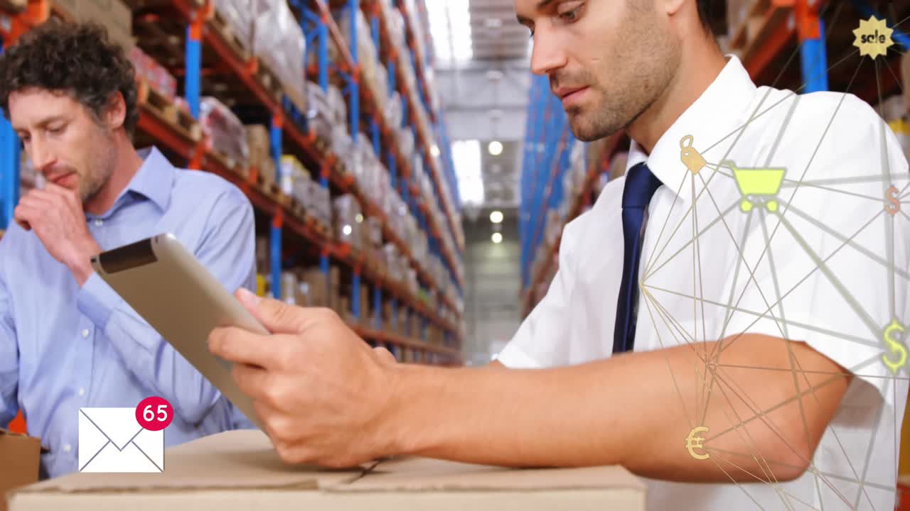 Envelope icon and globe of digital icons against man using digital tablet in warehouse