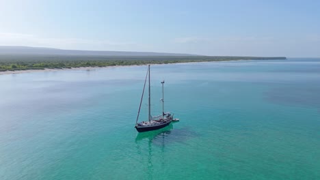 Aerial-orbit-around-remote-sailing-ship-in-exotic-turquoise-blue-water