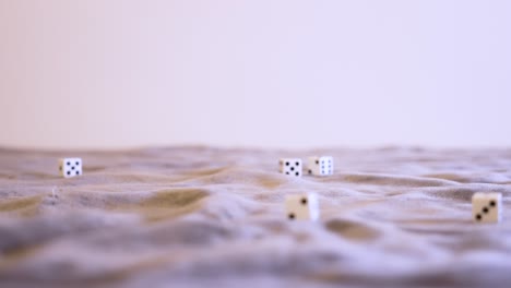 rolling six white dice in extreme slow motion at eye level