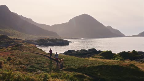 couple running with their dog on a scenic coastal path in vestarelen