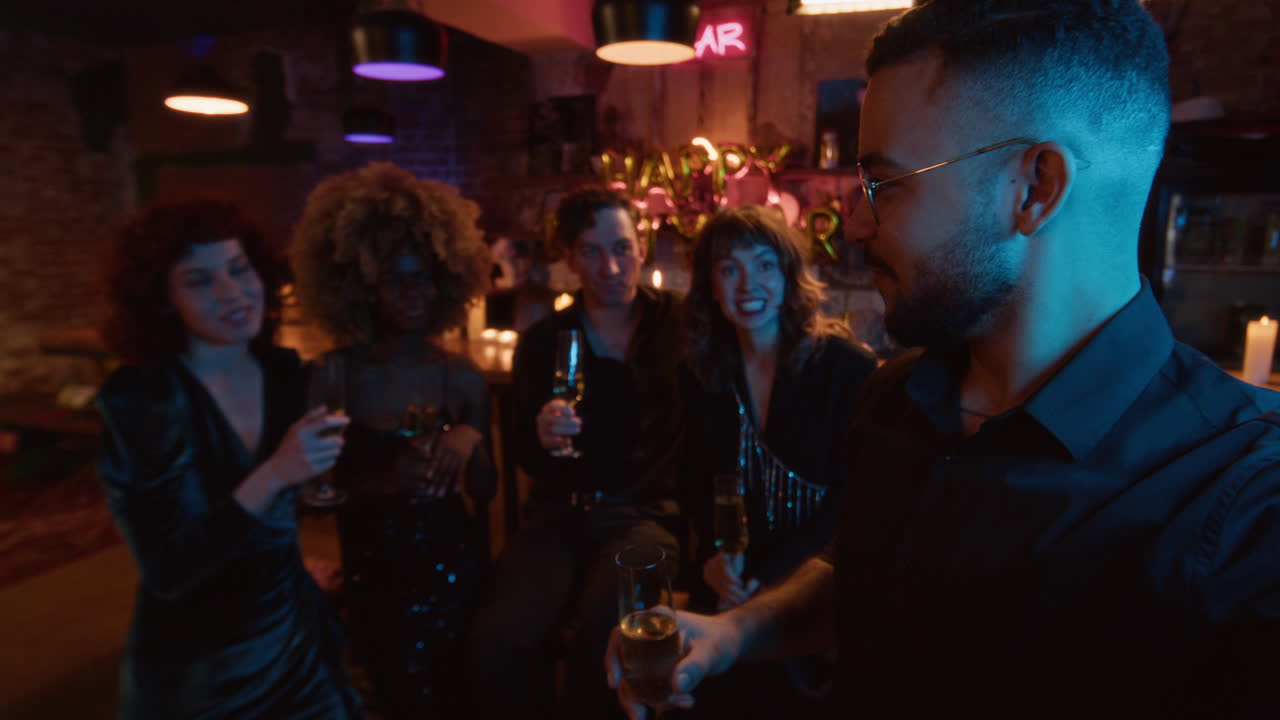 Friends celebrating at a bar with champagne