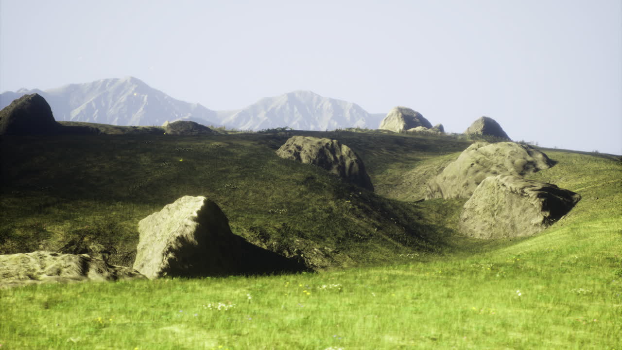 Vast landscape with rolling hills and distant mountains under clear sky