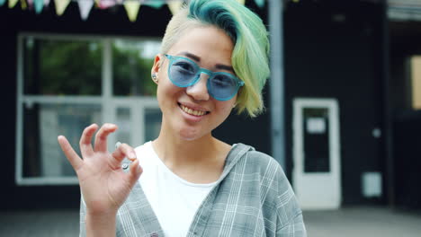 young woman with colorful hair and sunglasses