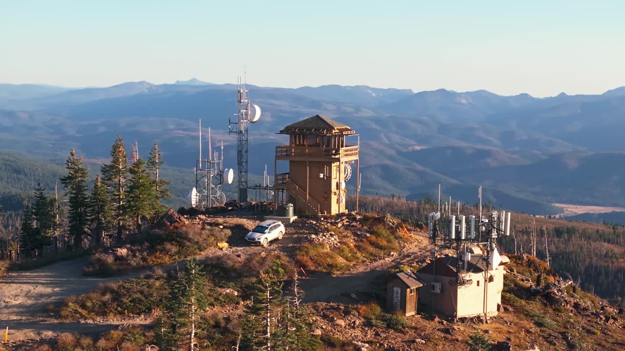 Aerial view of fire lookout tower in California, serene mountain landscape