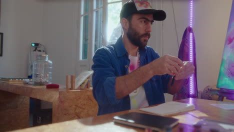 artist preparing to draw a picture at desk in studio