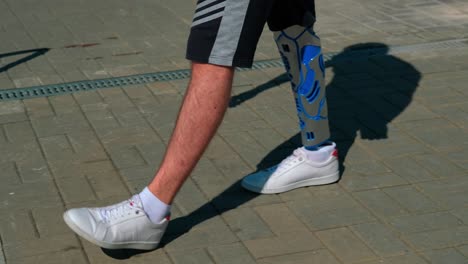 person with prosthetic leg walking outdoors