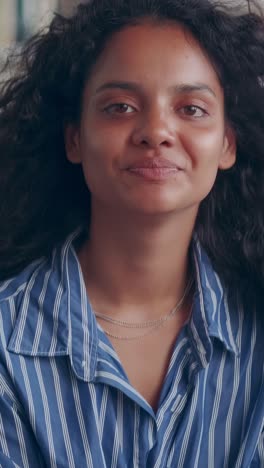 young happy sparkling indian woman smiling looks at camera and turns to side