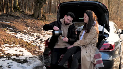 Kaukasisches-Paar-Trinkt-Warmen-Tee-In-Einem-Verschneiten-Wald.