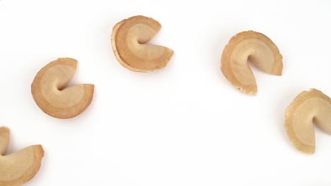 close-up of the traditional chinese fortune cookies shaped in circle spinning on rotating table. international traditional concept. isolated, on white background.