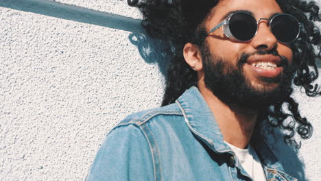 man with curly hair and sunglasses