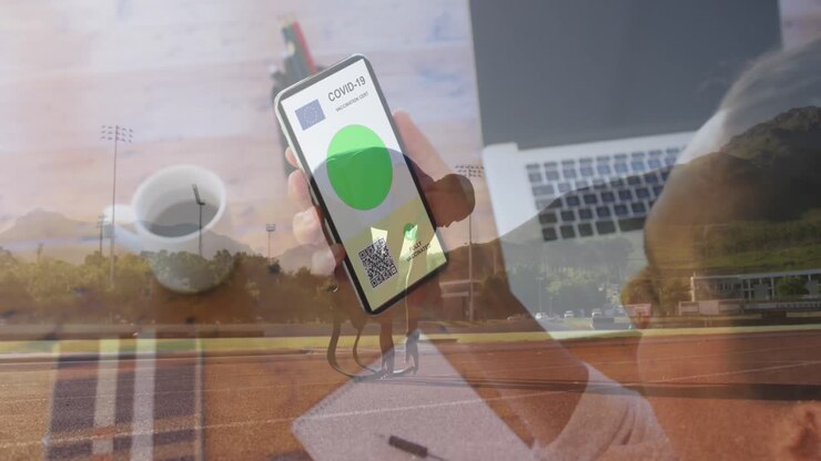 Woman holding a smartphone with qr code on screen against male athlete with prosthetics legs