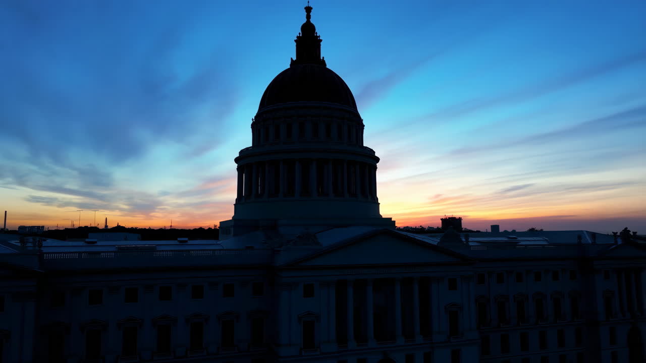 US Capitol Building Silhouette Against a Vibrant Sunset Sky