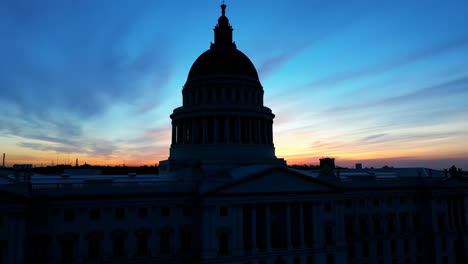 us capitol building silhouette against a vibrant sunset sky