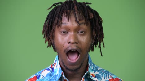 young handsome african tourist man looking shocked