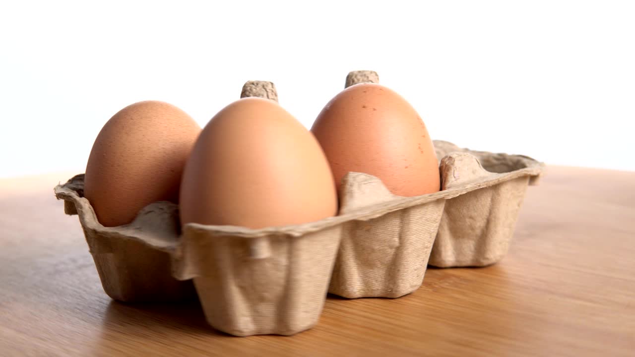 Six eggs on egg paper tray appear and disappear one by one on spin table