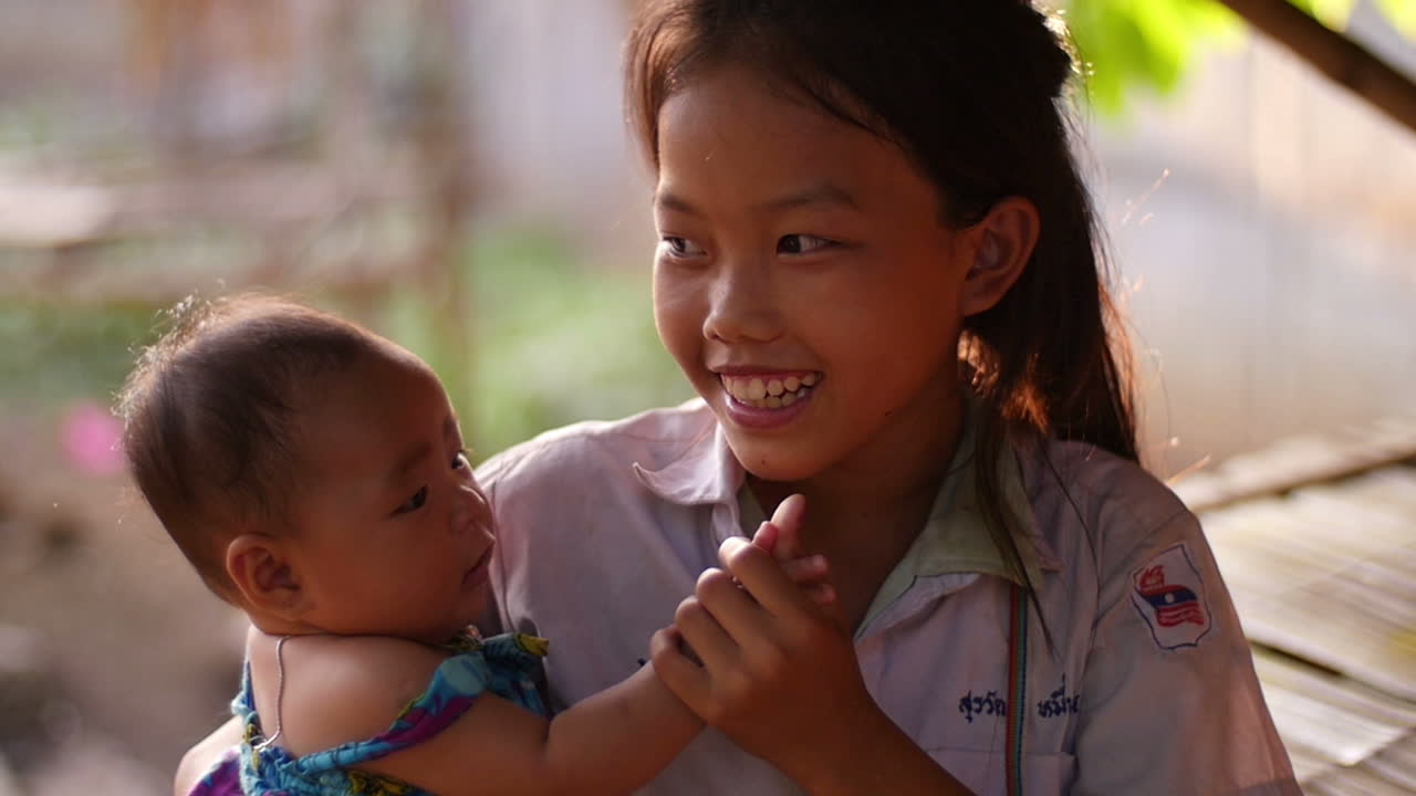 Girl Holding Baby Sister