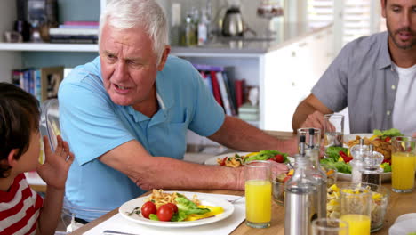 video of a family eating with grandparents