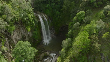 aerial view of a majestic waterfall in a lush green forest