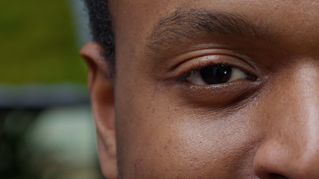 Macro shot of young man showing one eye and half of face
