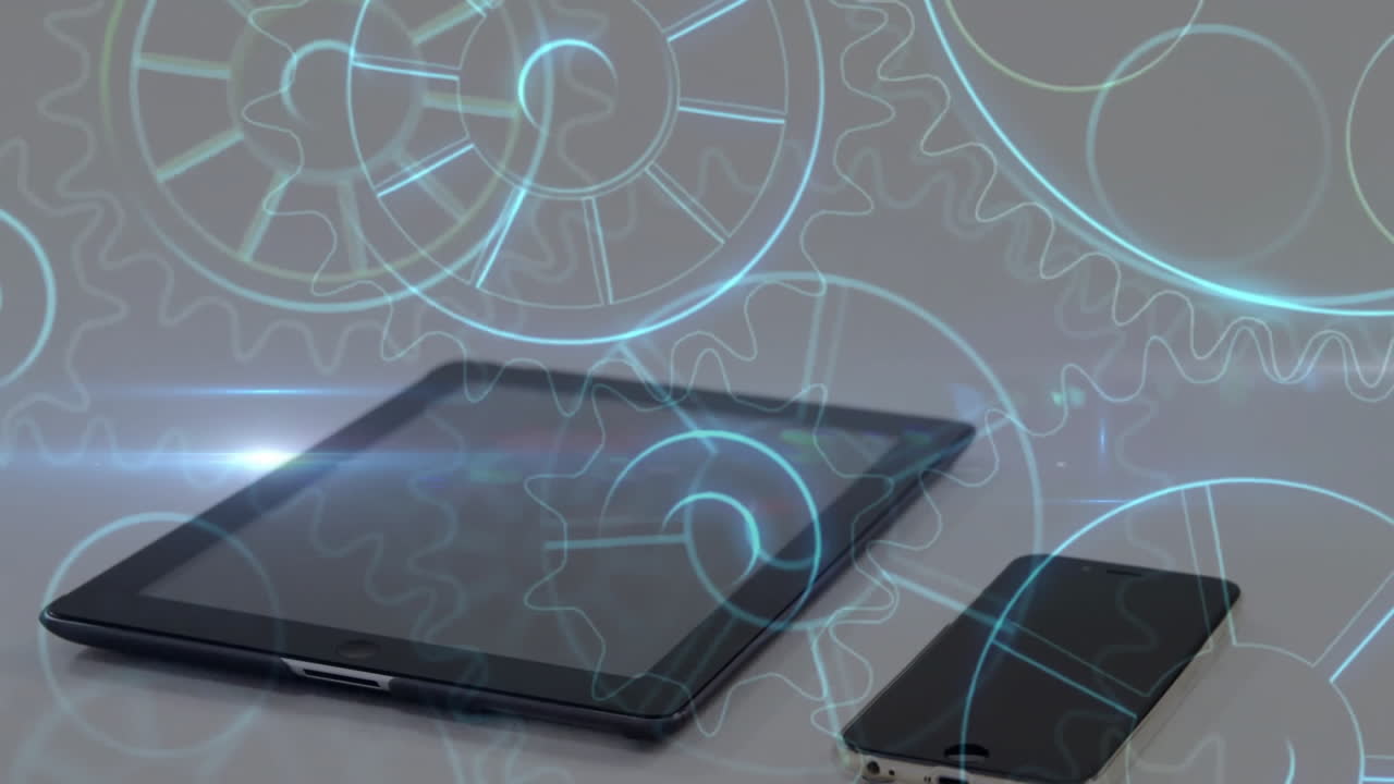 Digital gears animation over tablet and smartphone on white surface