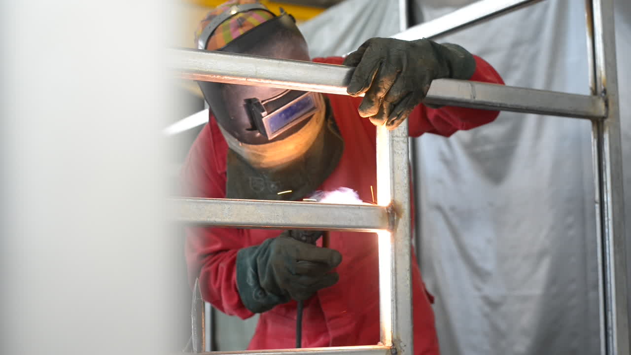 Front View Of Fabricator Welding Metal Structure In Fabrication Factory. slider