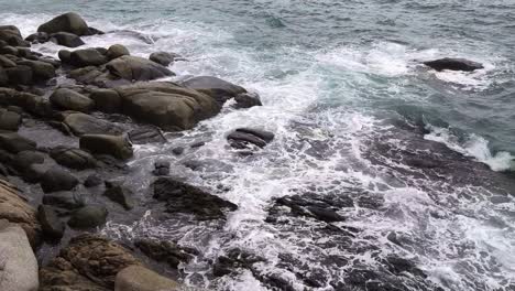 ocean waves crashing against rocks on a rocky shore