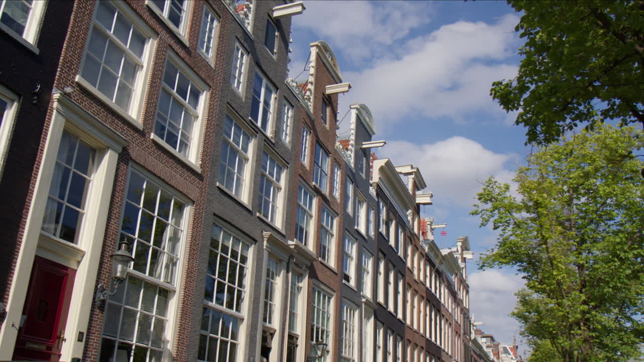 Typical Facade With Multiple Windows In Streetscape Of Amsterdam, Netherlands. POV Shot